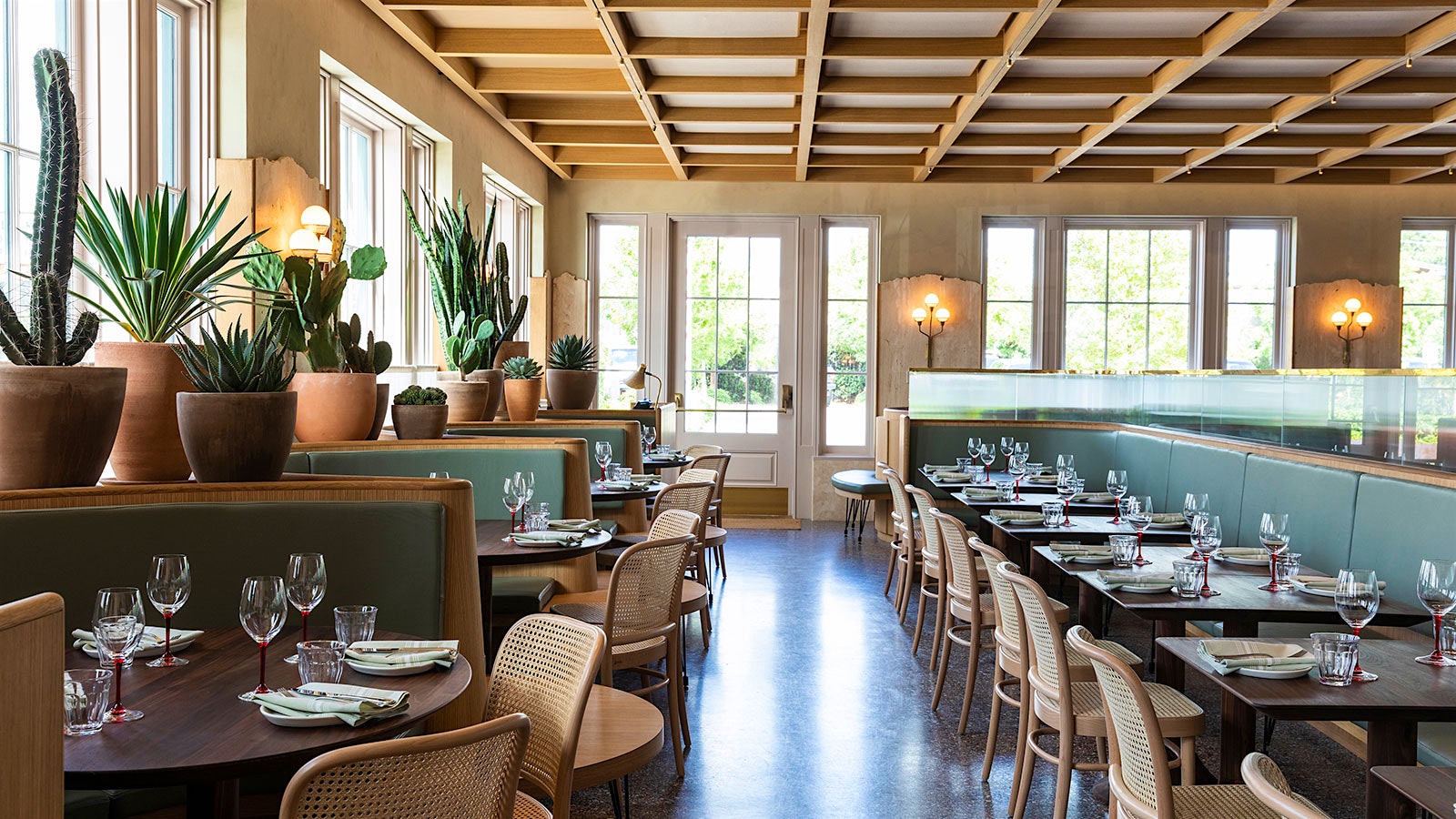  The contemporary-design dining room at Rosie Cannonball, with green booths and a white and wood coffered ceiling